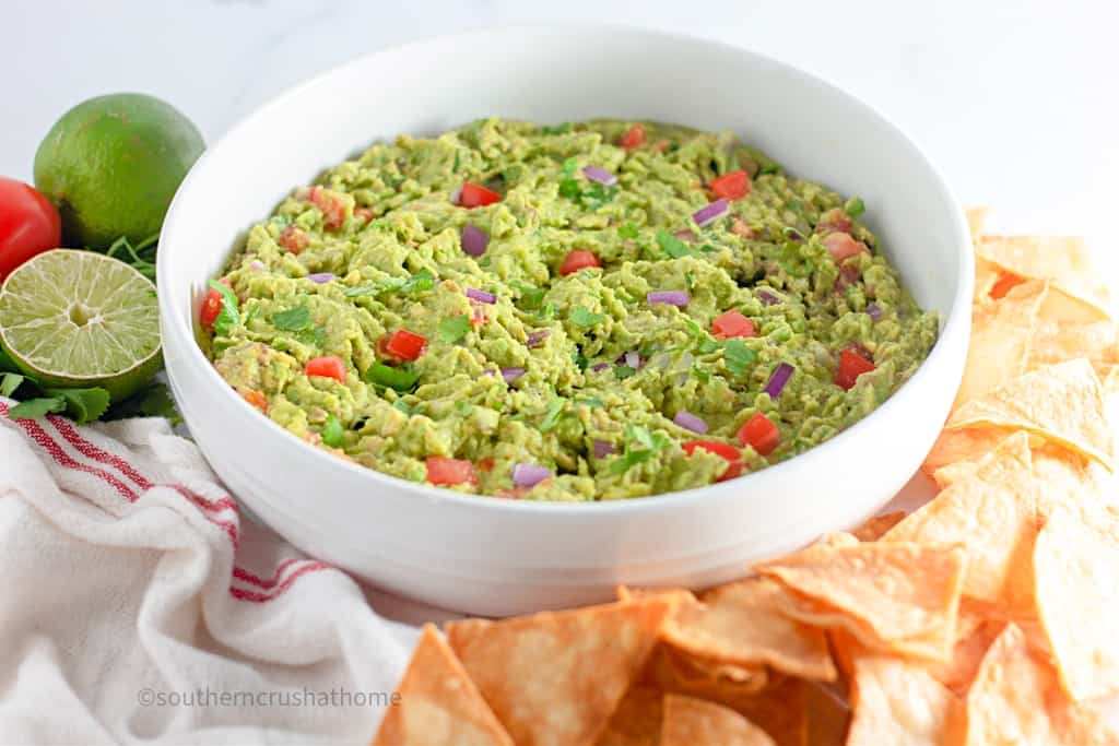 homemade guacamole in white bowl