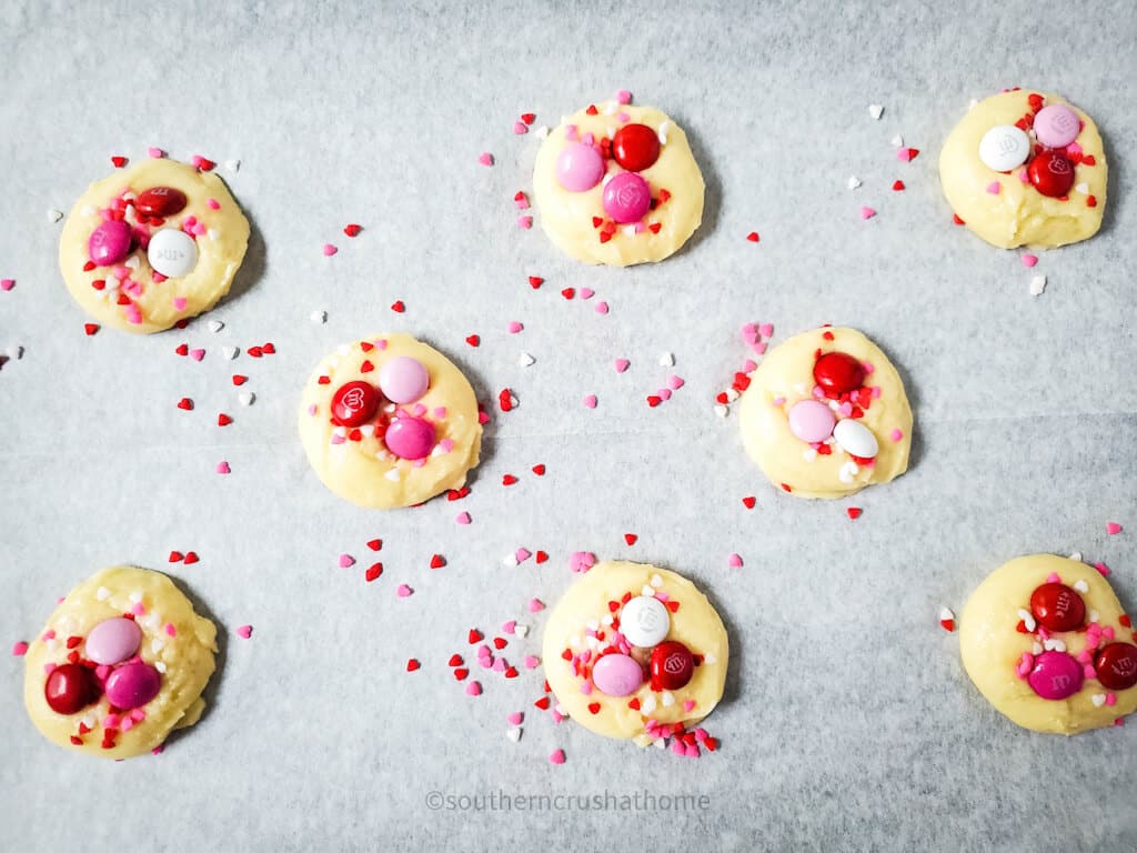 adding 3 m&m's tops of yellow cake mix cookies