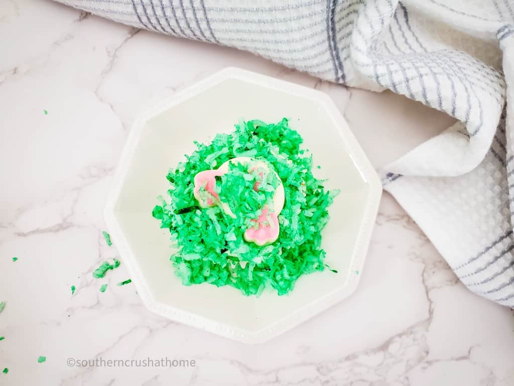 adding green coconut to the rest of the exposed icing