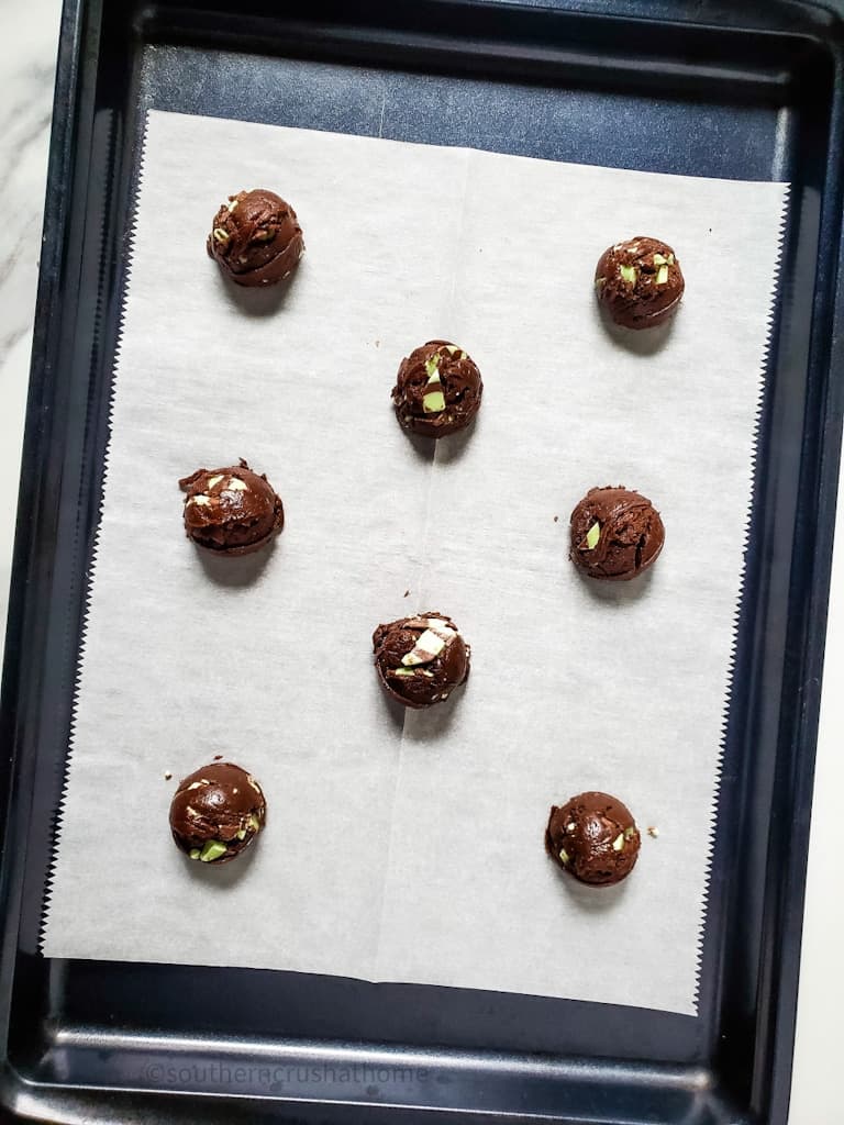 chocolate cookie dough balls on baking sheet