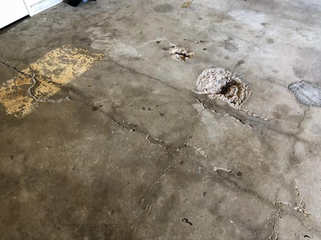 holes and cracks in old garage flooring