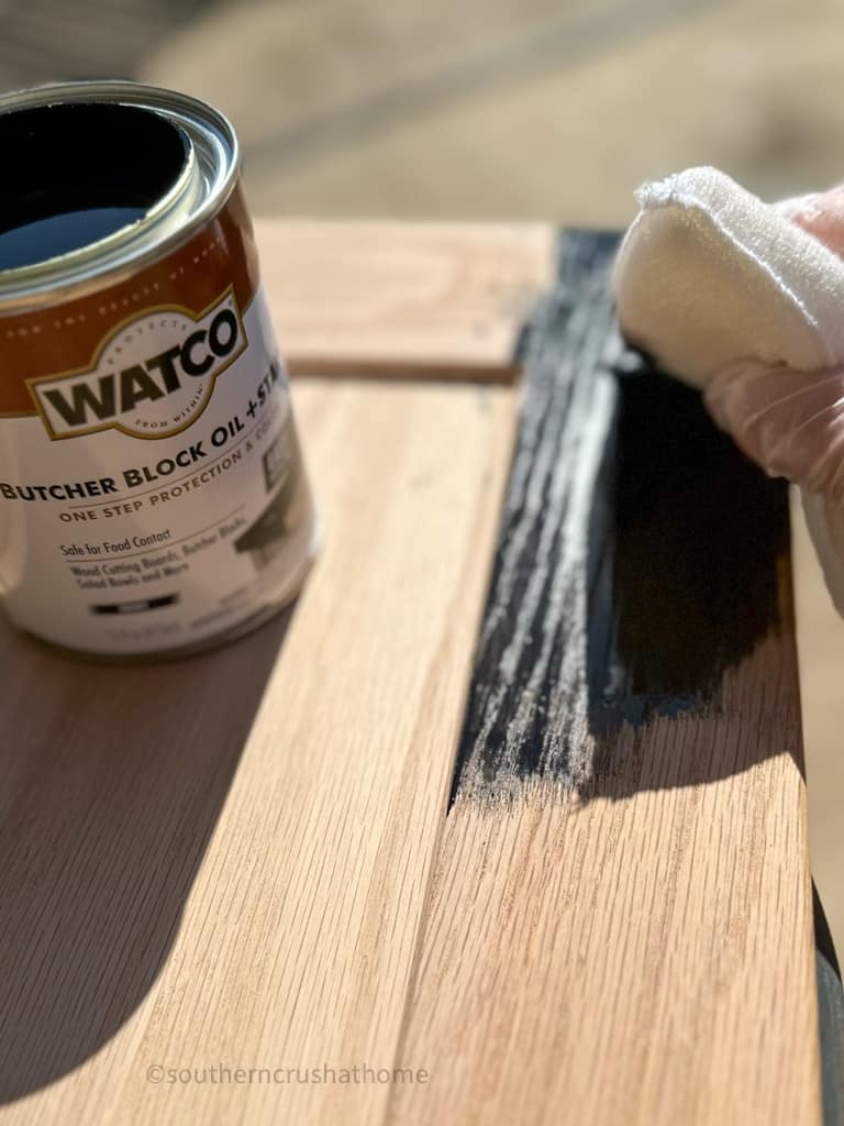 wiping on black ebony watco butcher block oil & stain to cabinet door