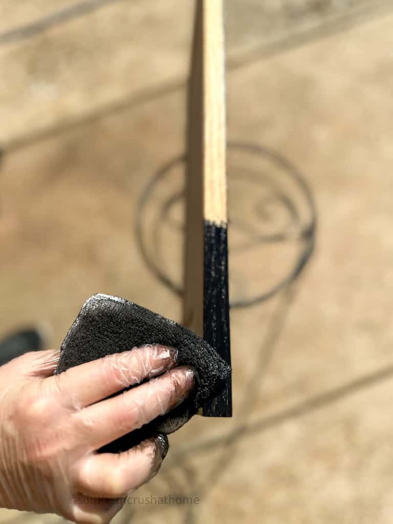 wiping on black ebony watco butcher block oil & stain to cabinet door edge