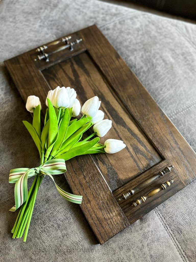 view of faux white tulips on top of watco butcher block oil & stain on woodend ottoman tray