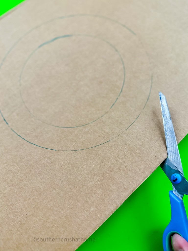 cutting out cardboard circle wreath base