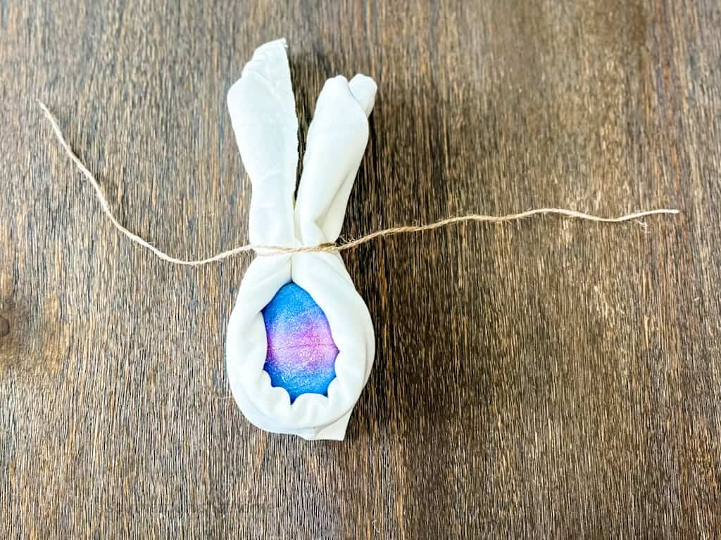 tying of twine on easter bunny napkin folding idea