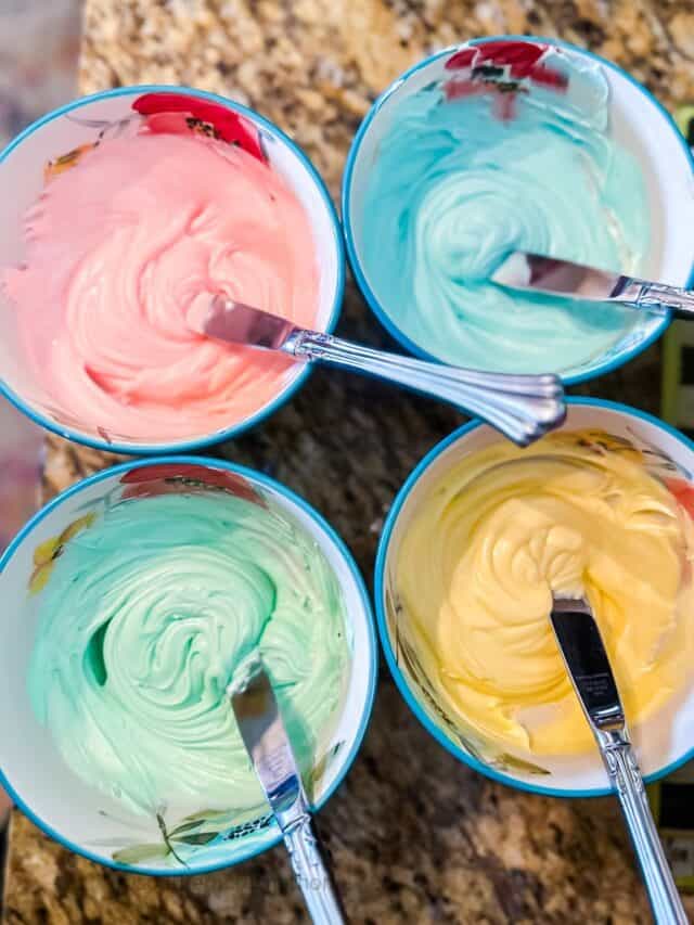 colored icing in four bowls