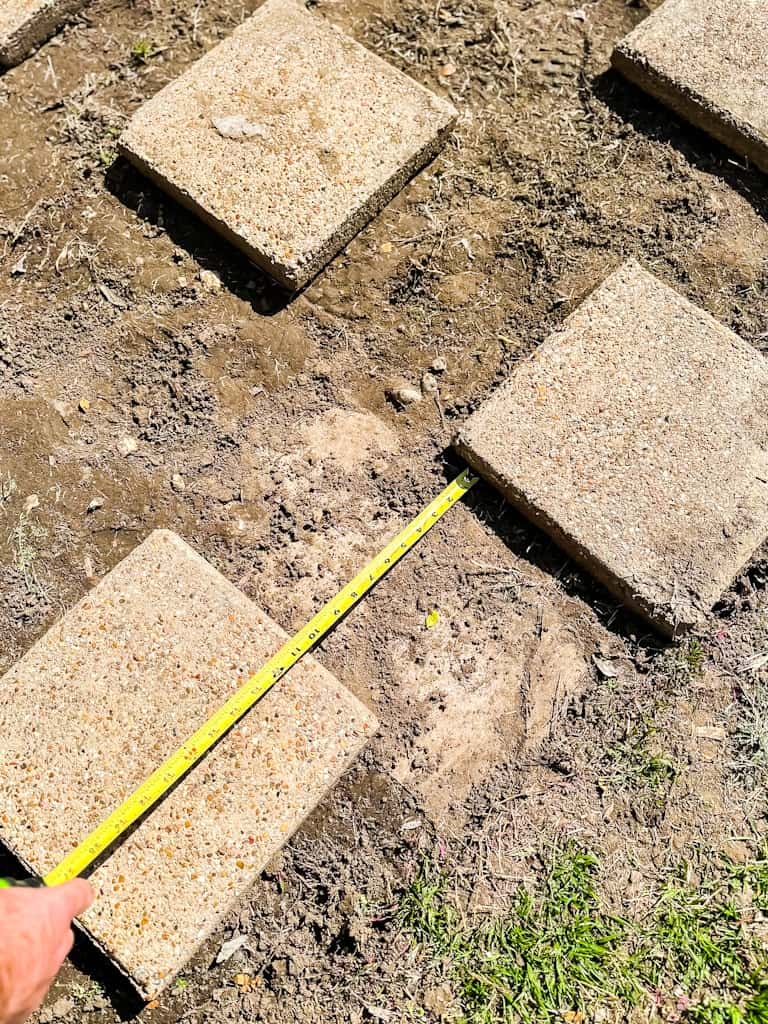 measuring out concrete stepping stones for garden pathway