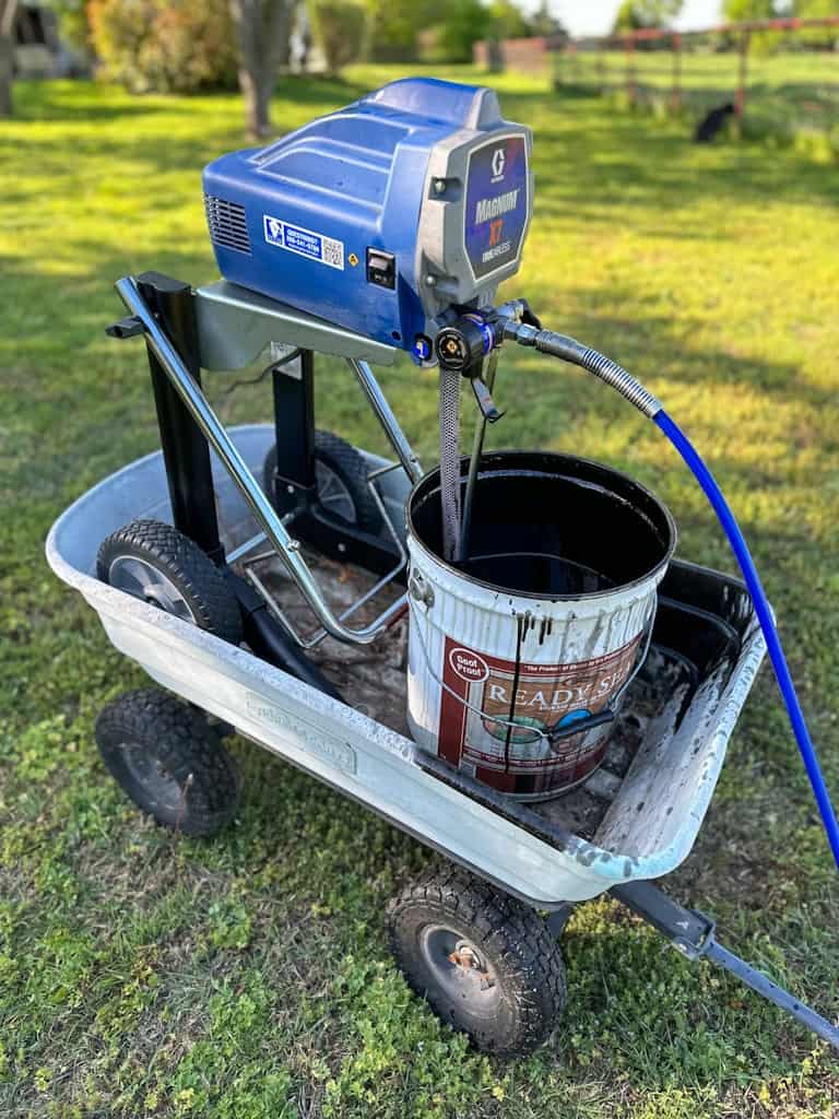 fence stain airless paint sprayer set up in wagon