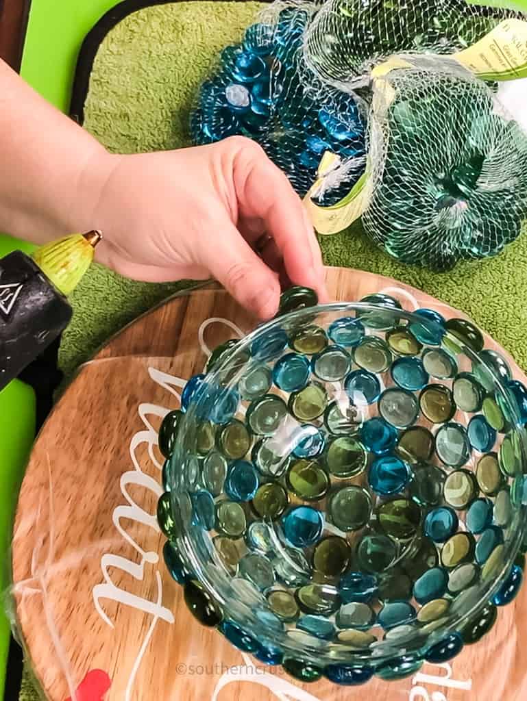 gluing glass gems on a clear bowl