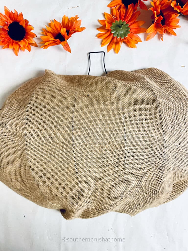 add burlap fabric to pumpkin wreath form