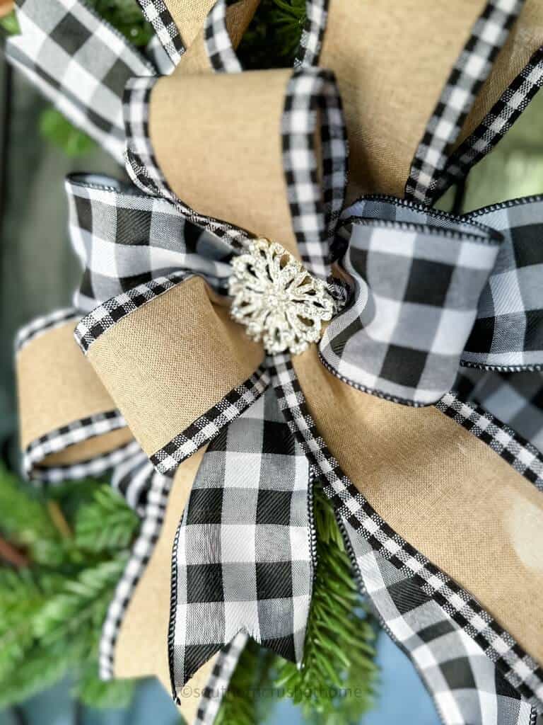 up close finished multi-layer buffalo check bow on a grapevine wreath