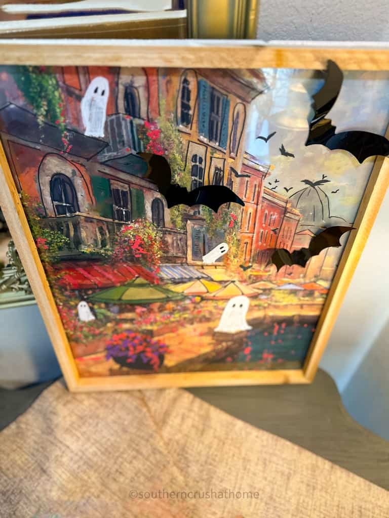 overhead view of ghost painting trend on thrifted artwork