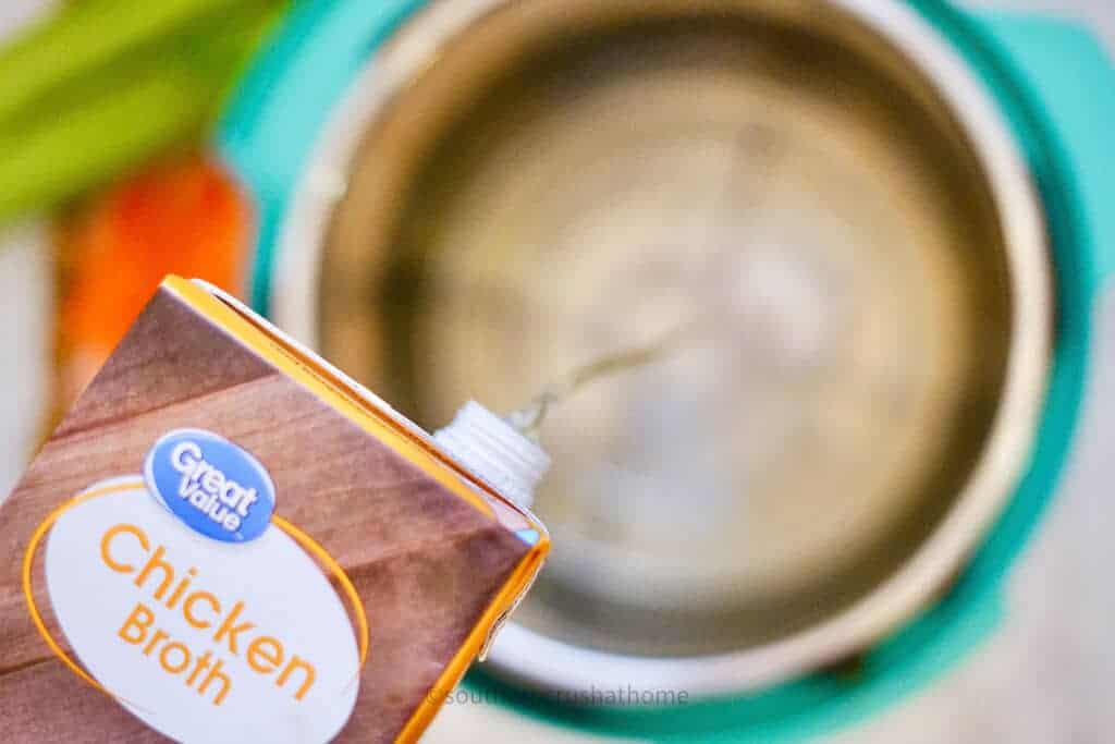 pouring chicken broth into instant pot