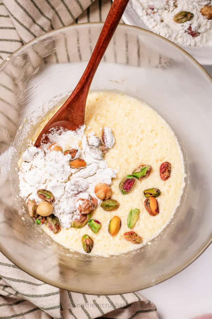 mixing in dry ingredients for pistachio cake