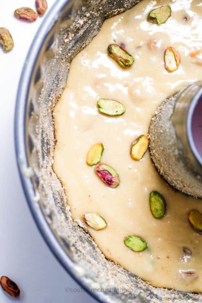 pour pistachio cake batter into bundt cake pan