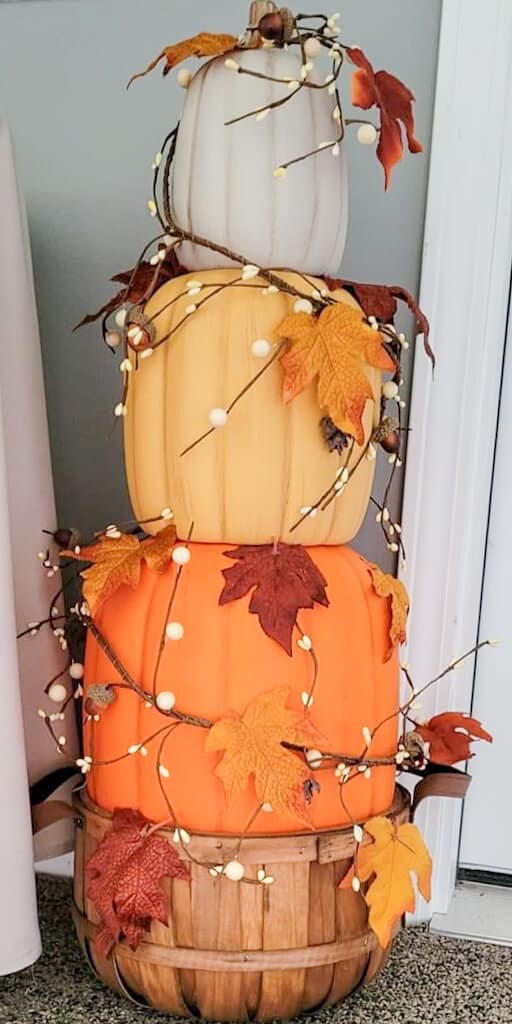 bushel basket with stacked pumpkins