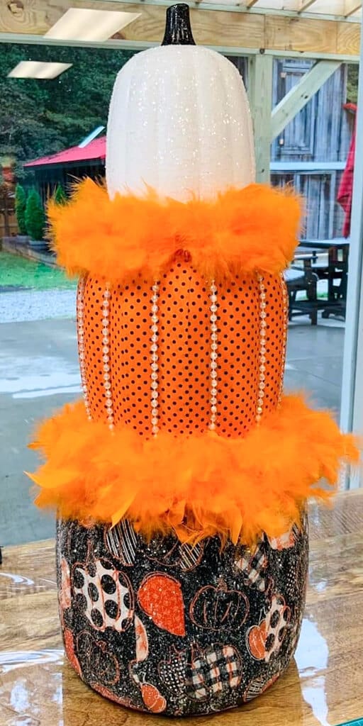 boa feathers and bling on stack of pumpkins