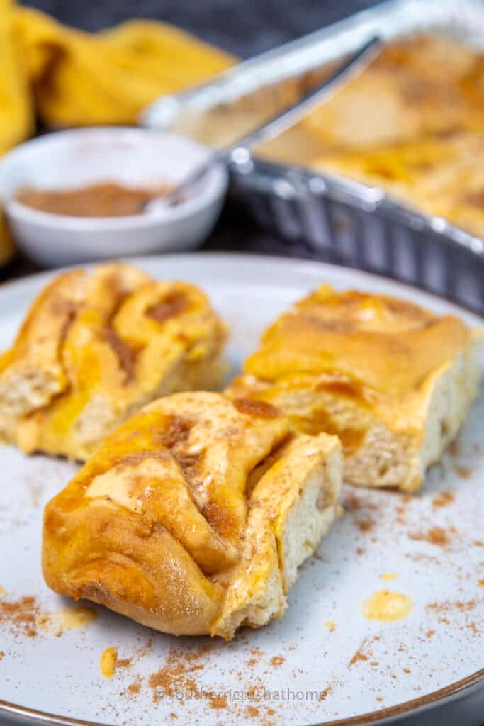 final image of pumpkin cinnamon roll casserole slices on plate