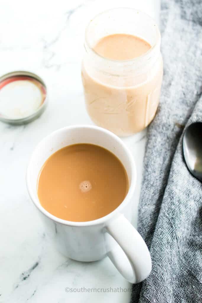 coffee in white mug with pumpkin spice creamer
