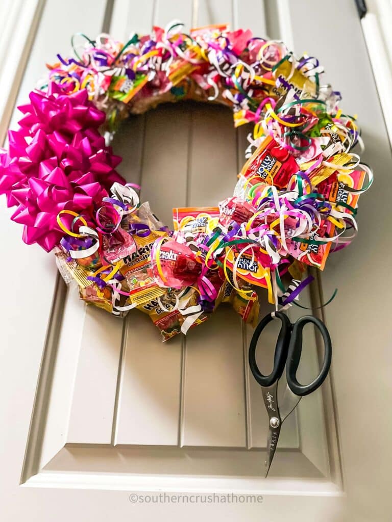 scissors hanging from bottom of candy wreath