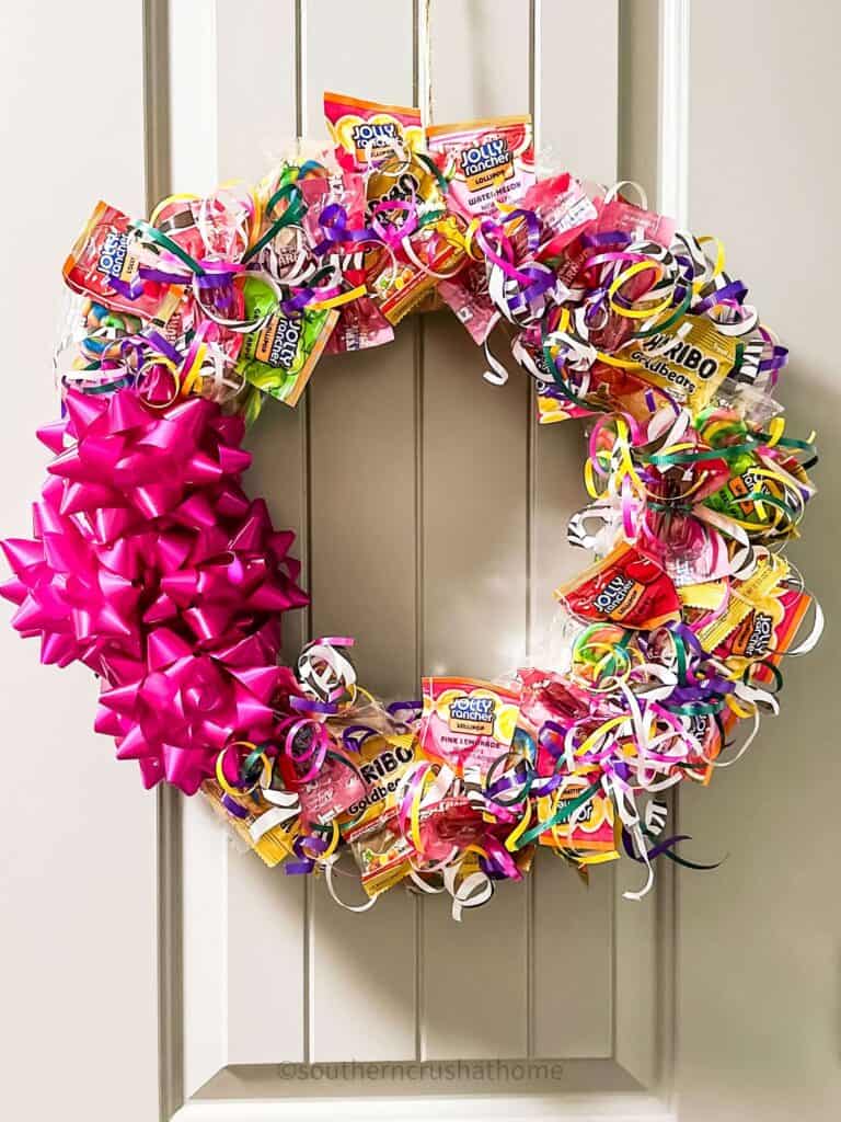 halloween wreath with candy hanging on door