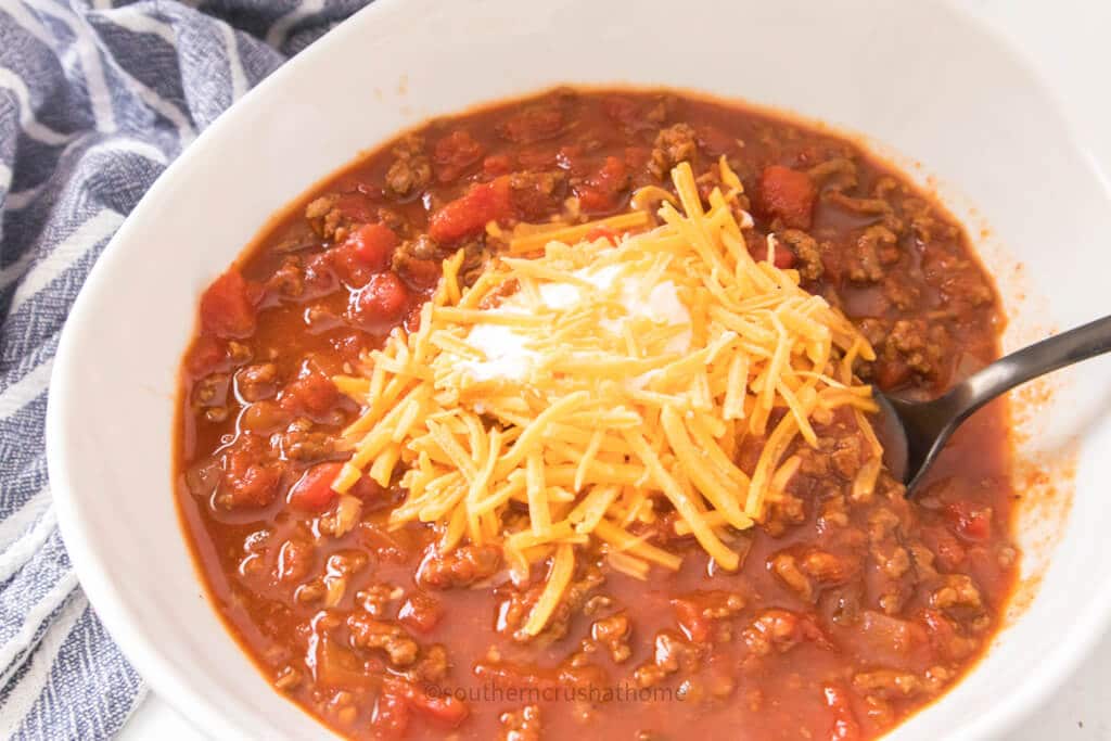 toppings on chili in bowl with spoon