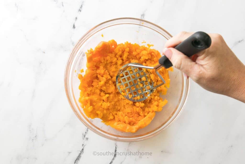 mashing sweet potatoes