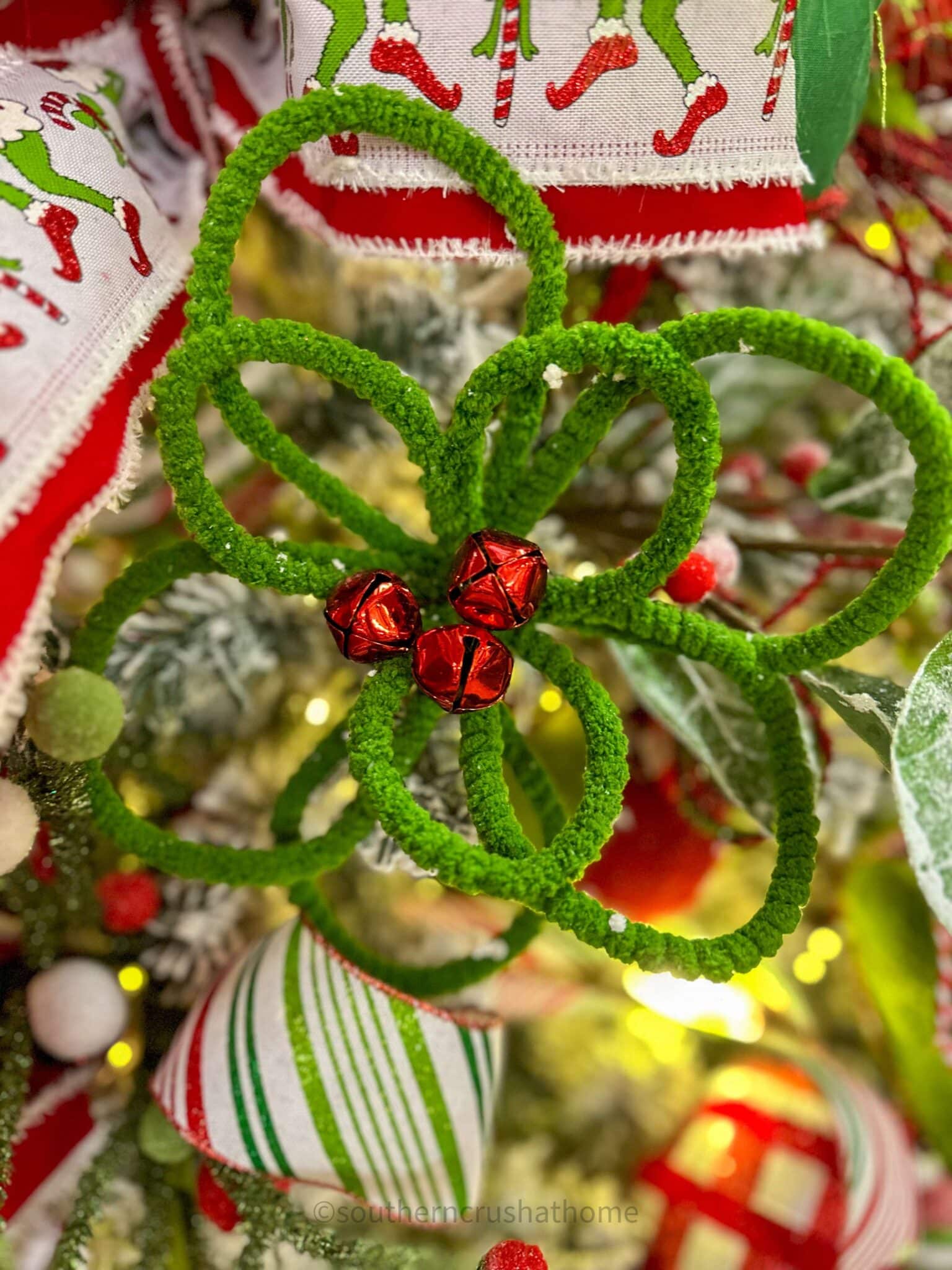 green flower with red jingle bells in the center