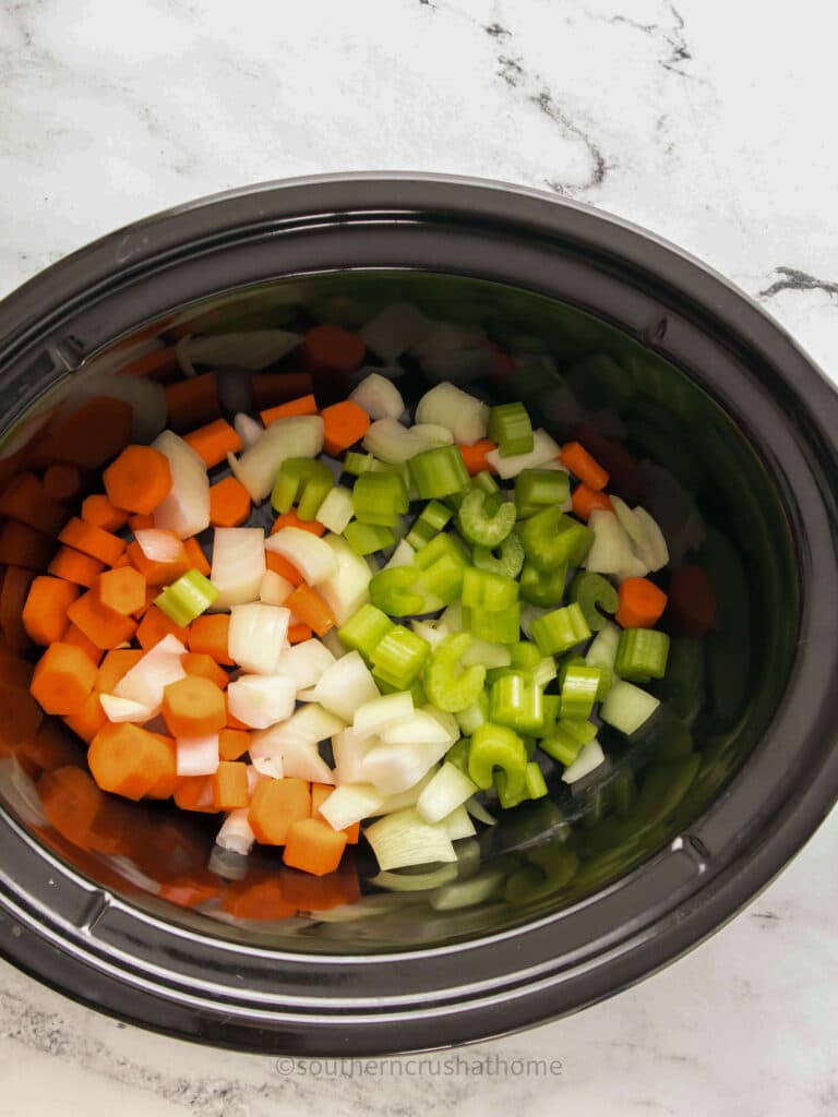 chopped veggies for pot roast in slow cooker