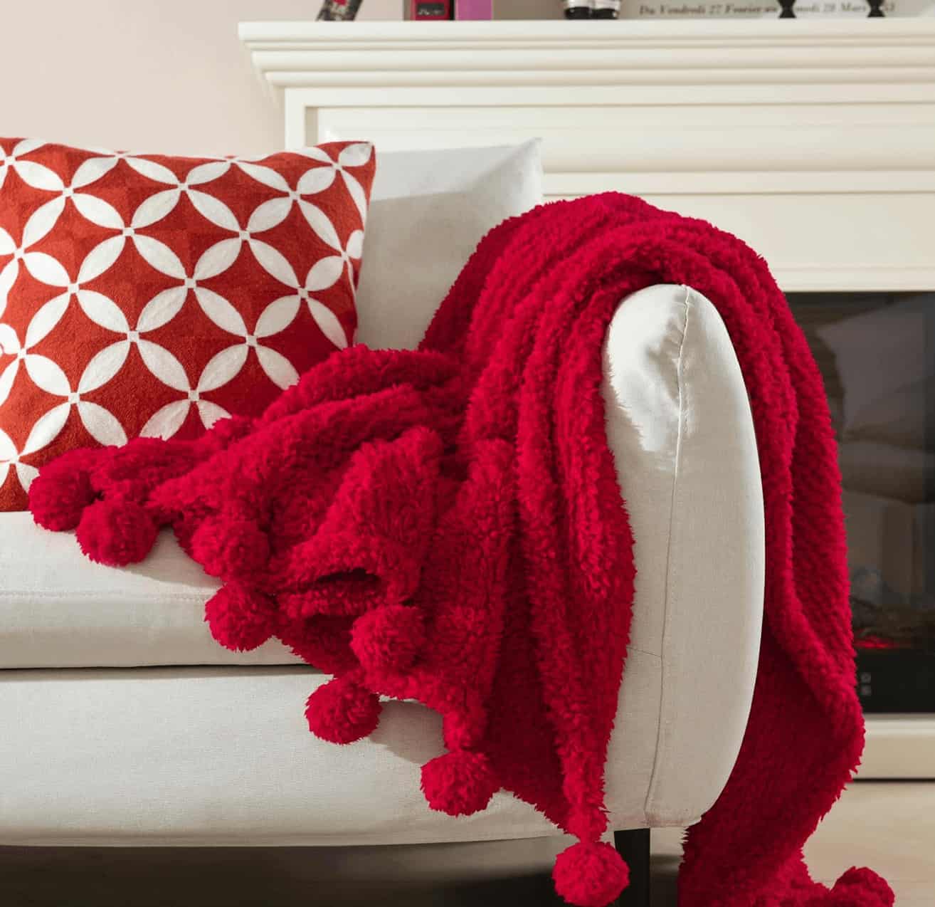 red throw with pom poms