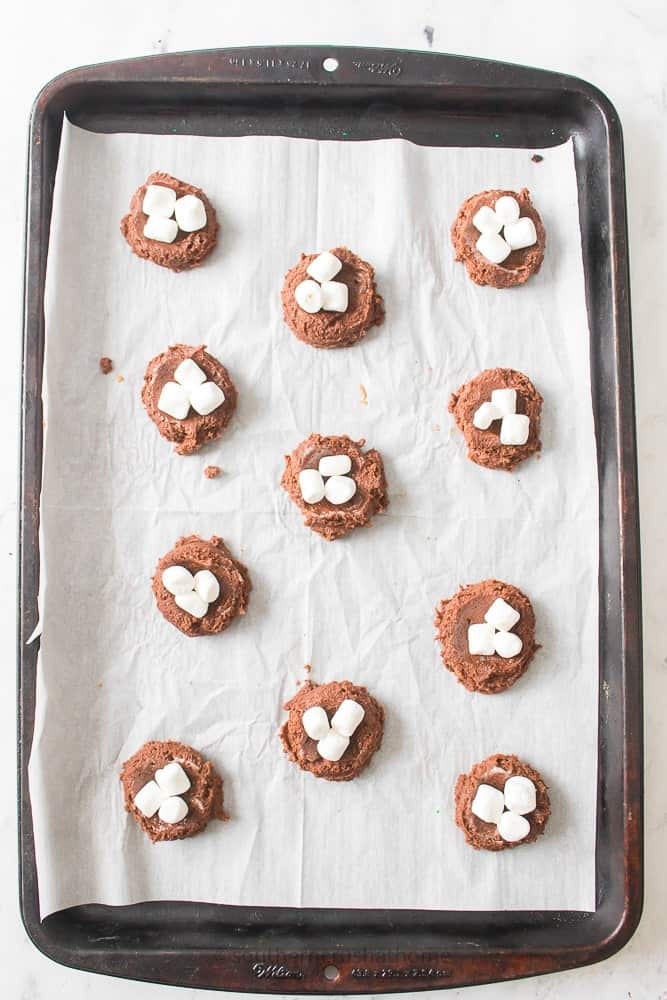 adding marshmallows to top of cookie dough