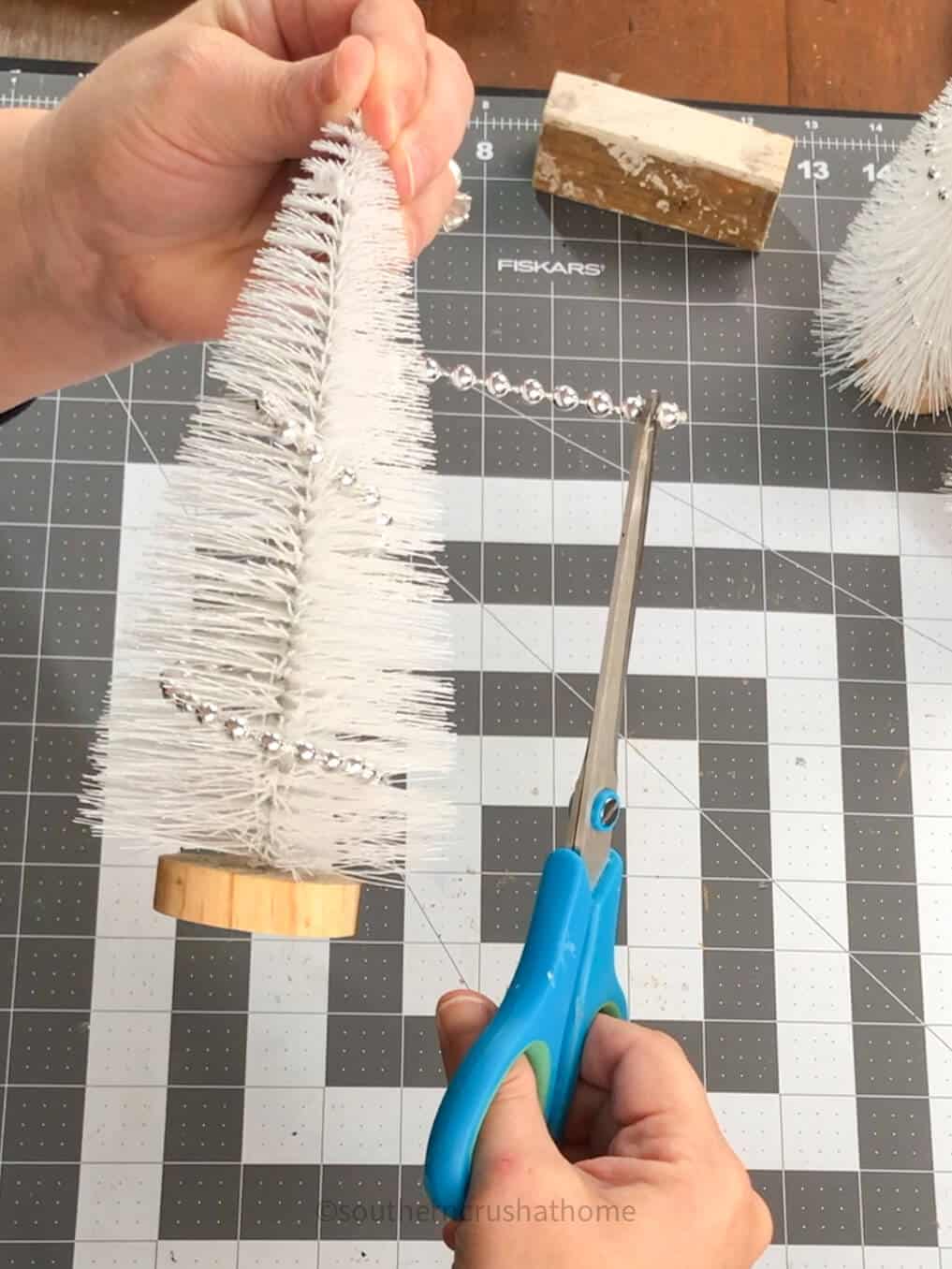 removing silver bead garland from bottle brush tree