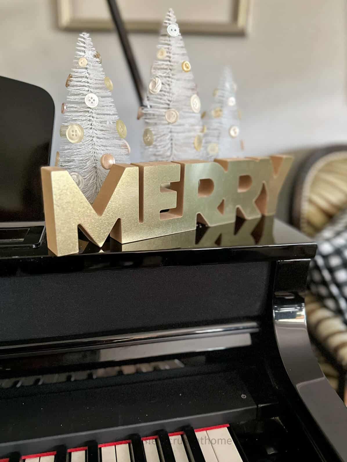 bottle brush trees on display with merry sign