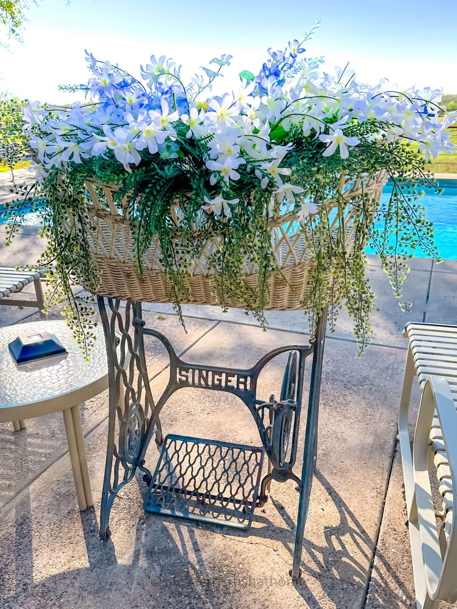 singer sewing machine vintage with faux florals by the pool