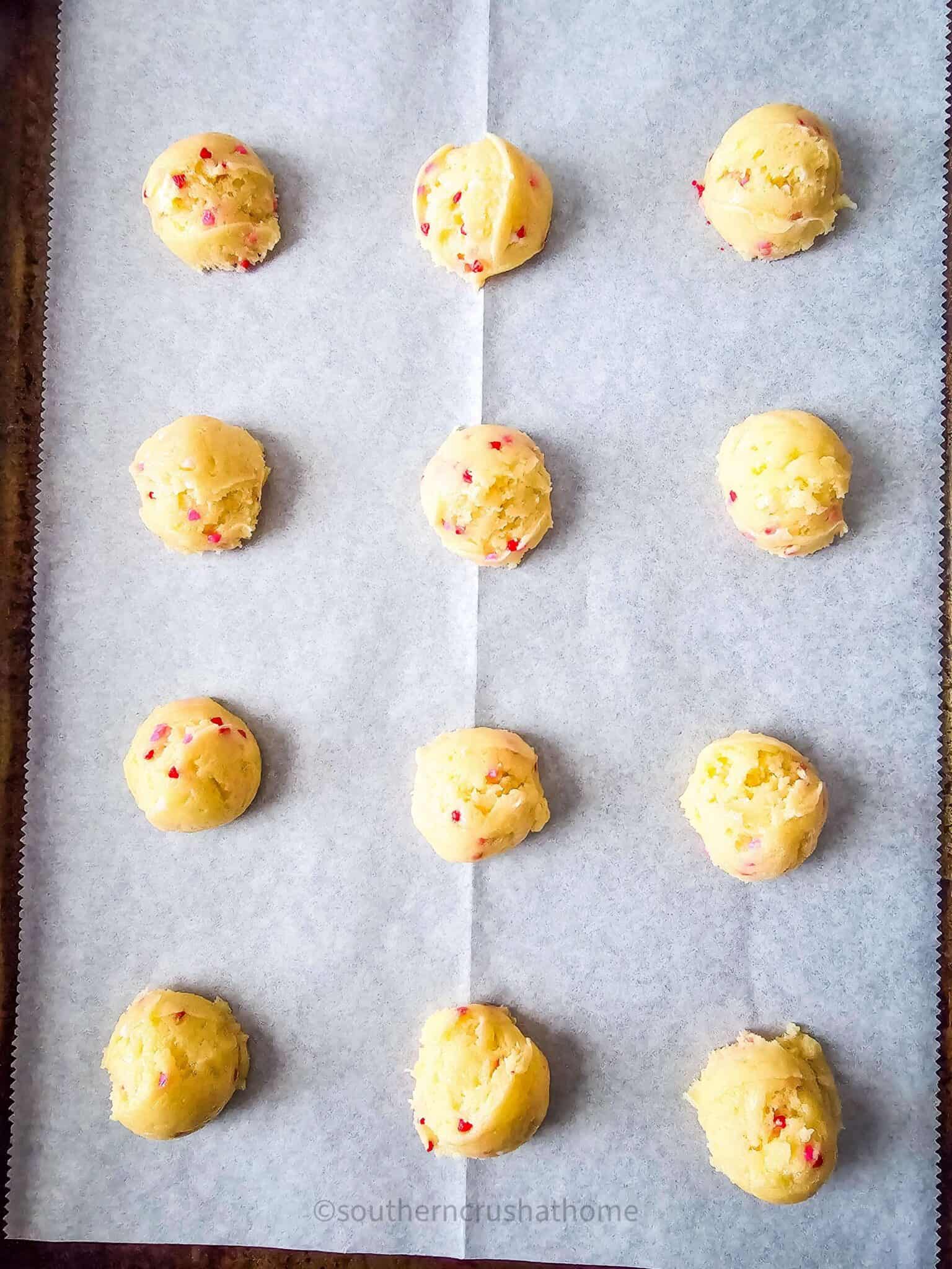 cookie dough balls on parchment paper