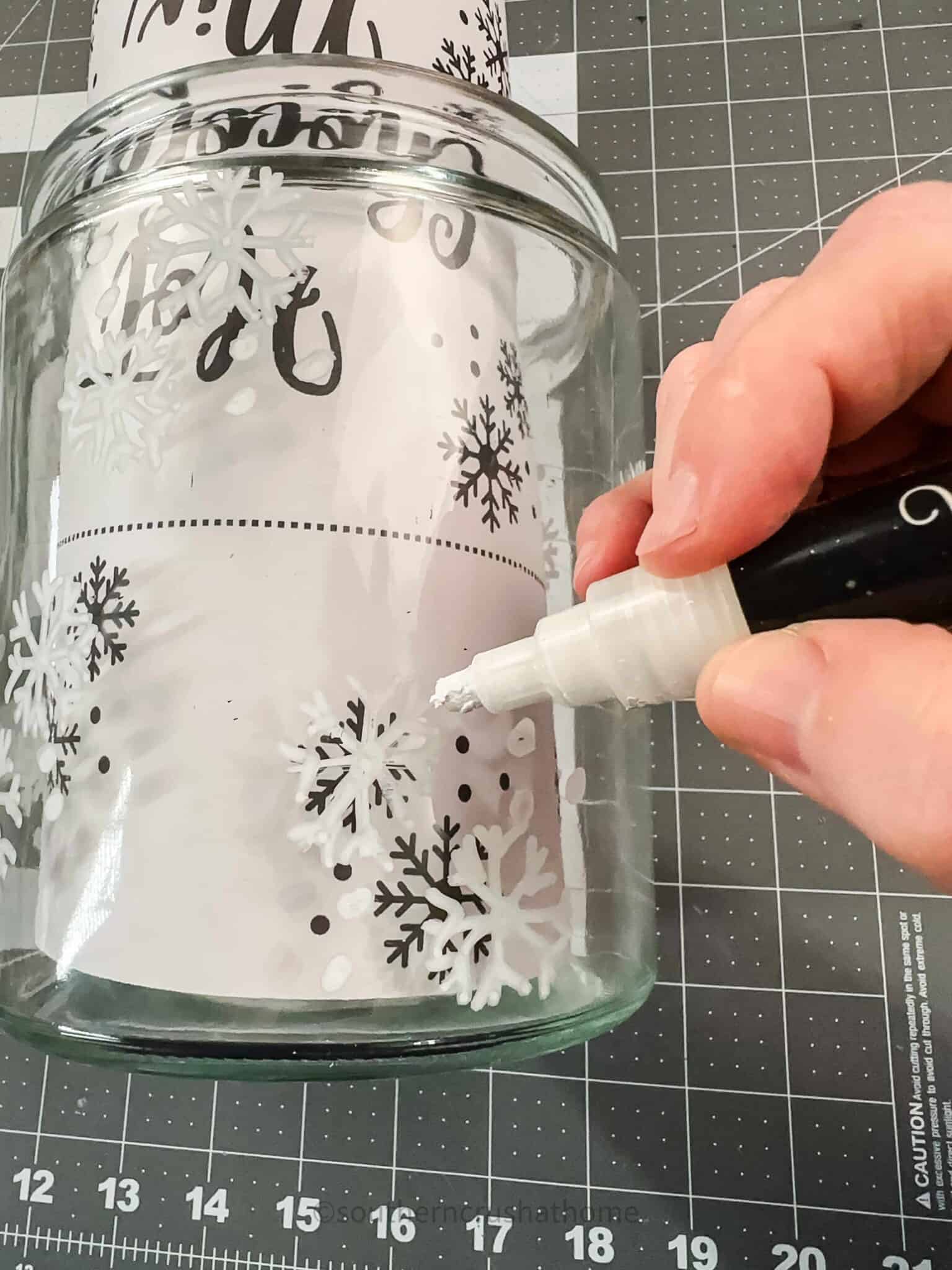 tracing snowflakes onto jar