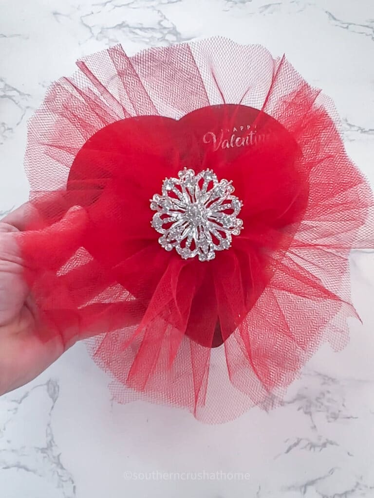 holdng view of tulle bow for valentine's box of chocolates