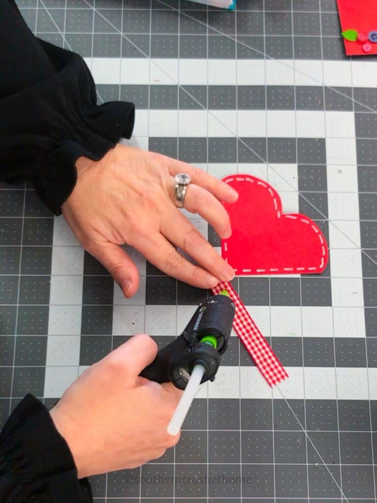 gluing ribbon onto paper heart