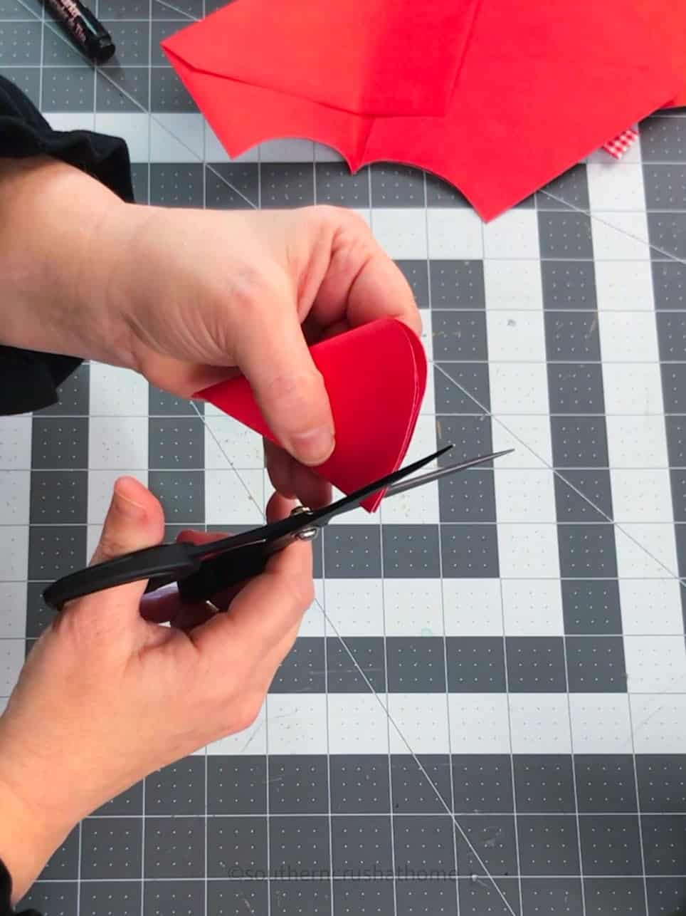 trimming corners of paper heart bookmark