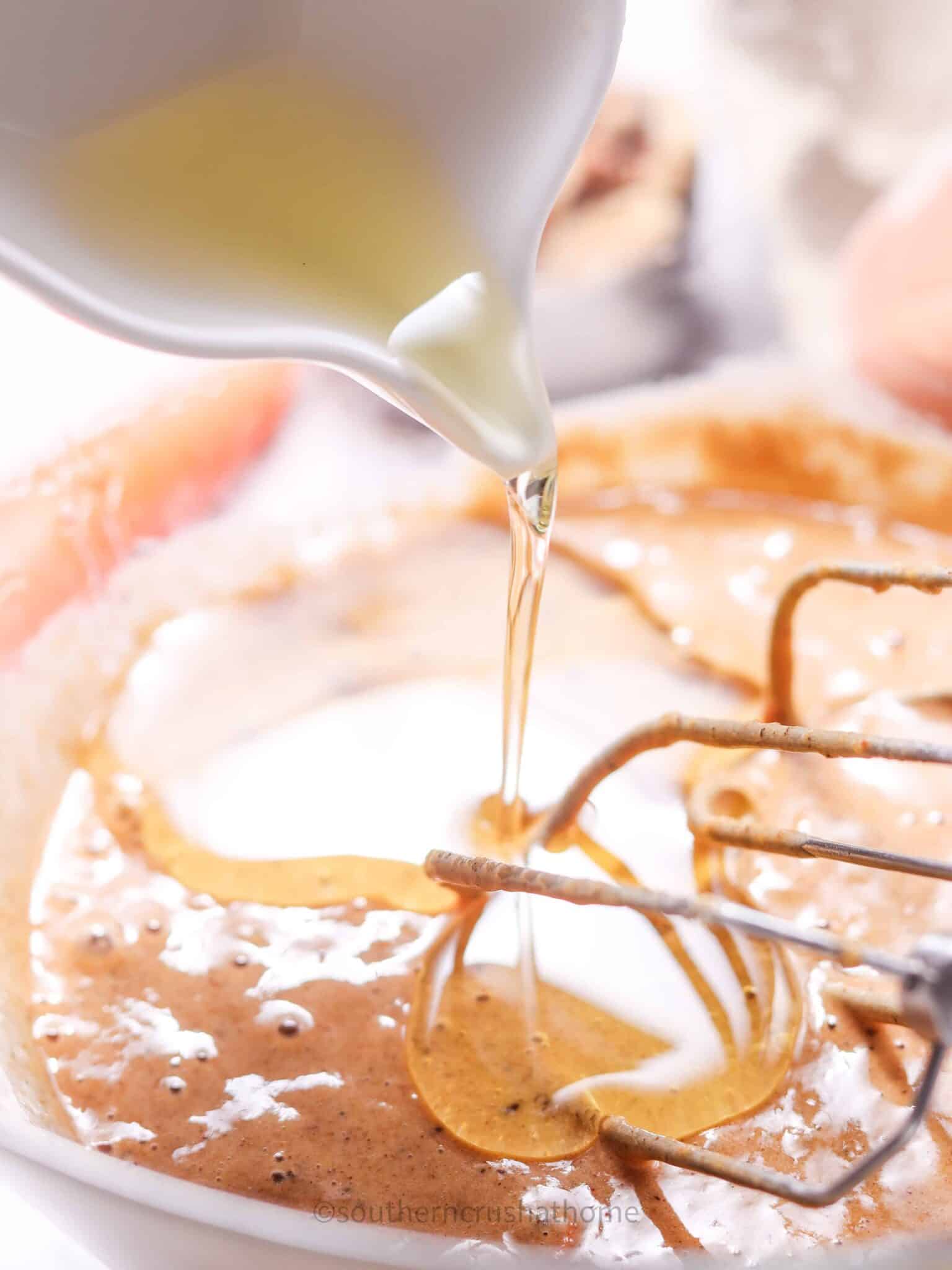 adding oil to carrot cake batter