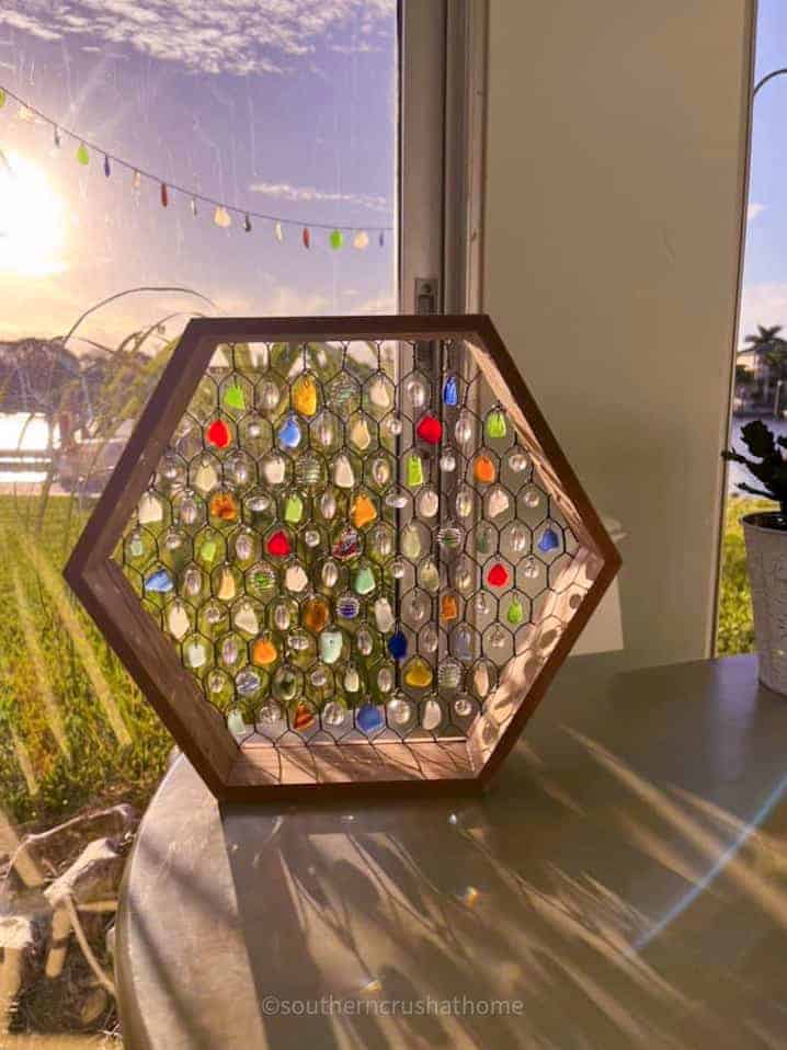 hexagon sun catcher sitting in a window