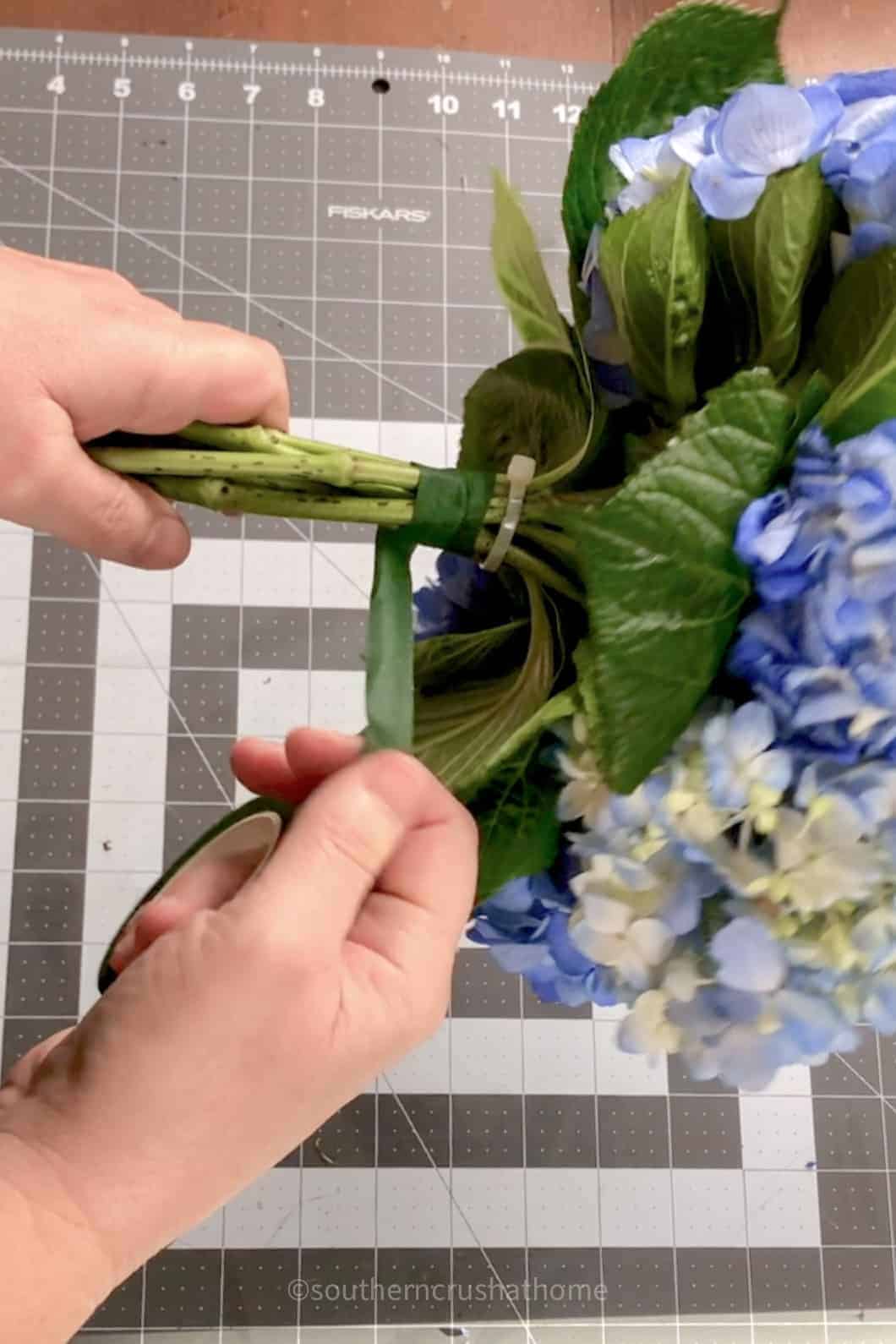 adding floral tape to bouquet
