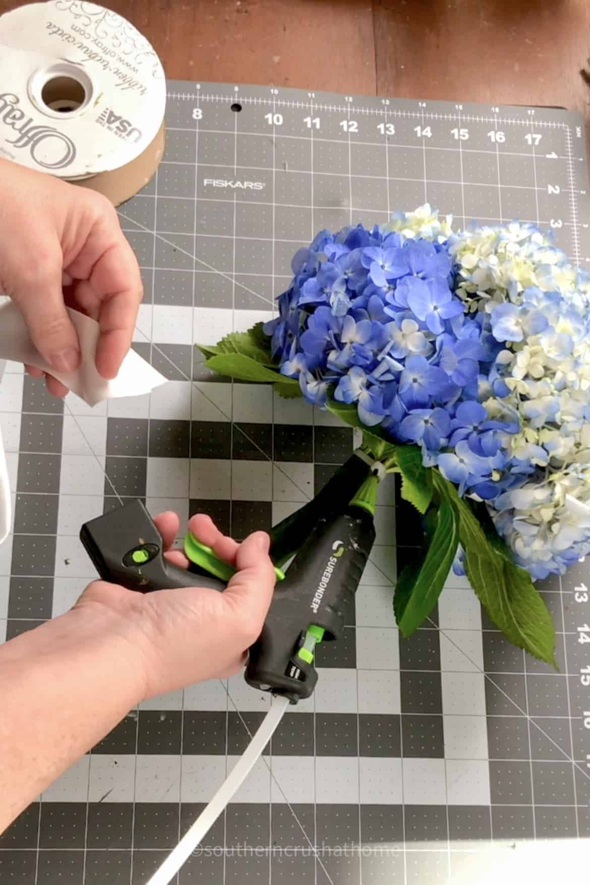 adding ribbon to bouquet