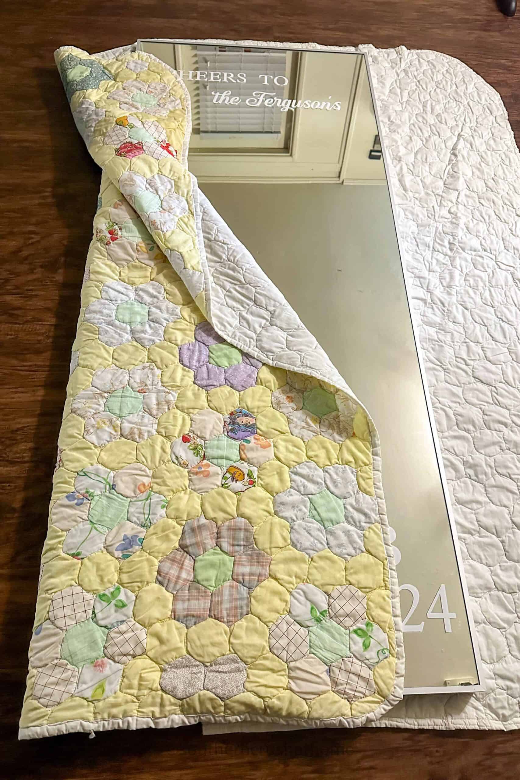 wrapping up wedding mirror in quilt