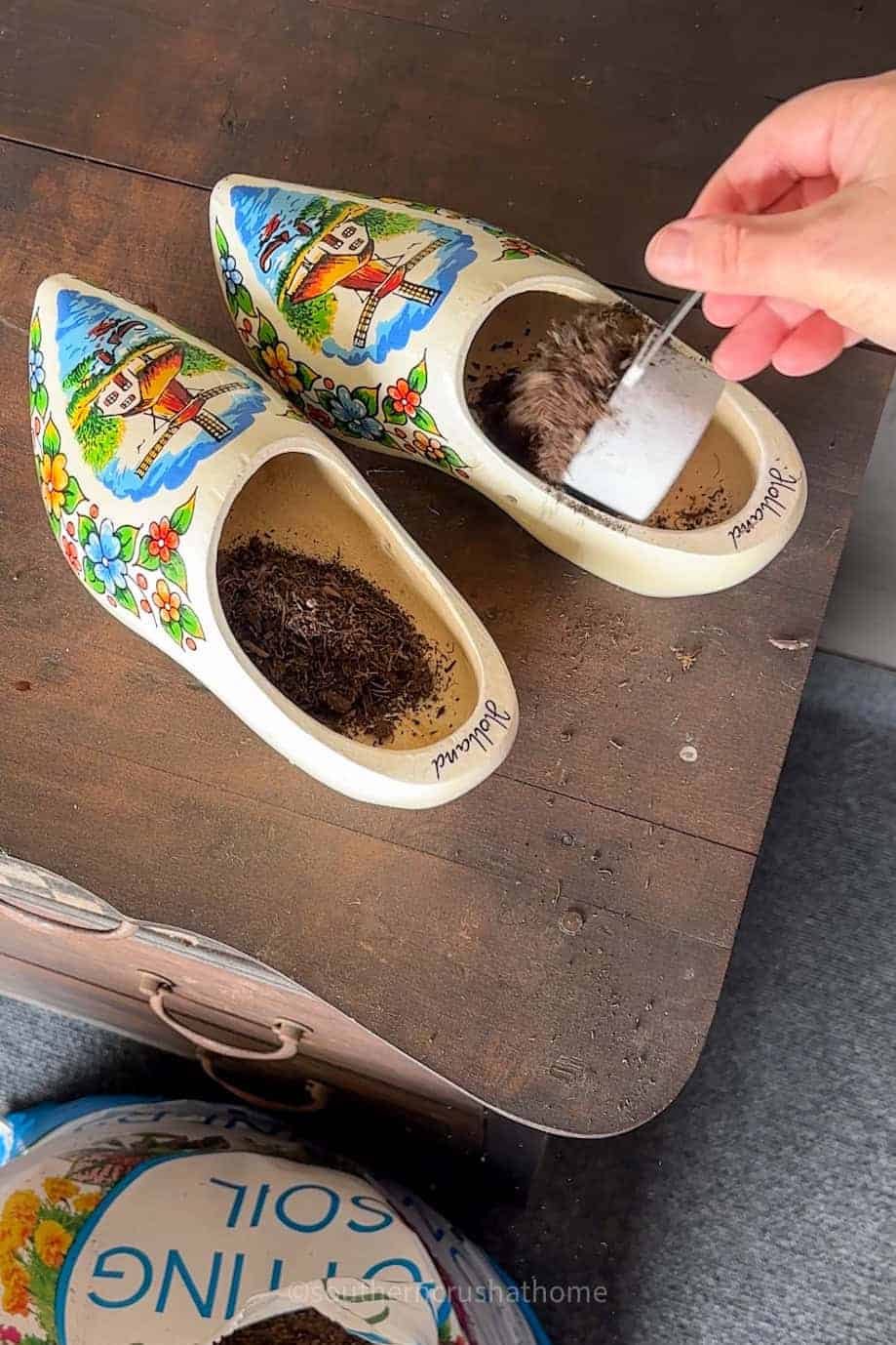 adding planting soil to clogs