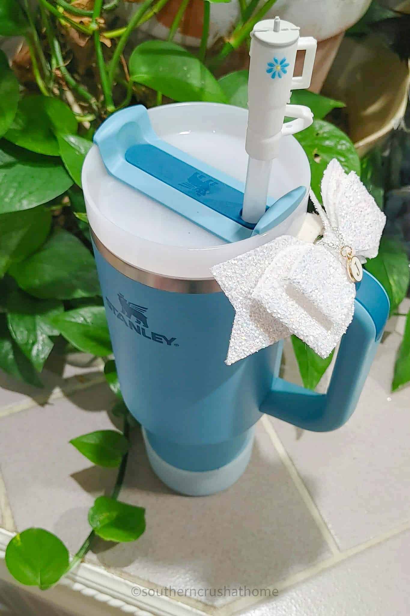 blue Stanley Tumbler with white bow and tiny Stanley straw cover