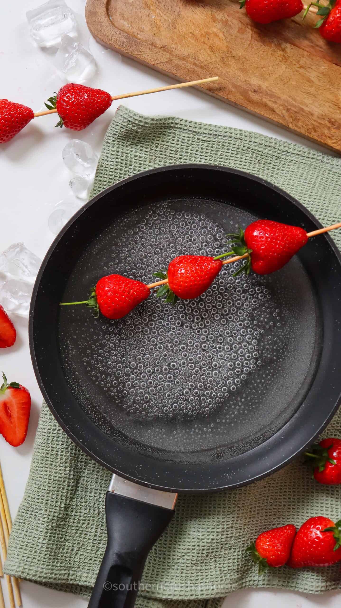 dipping strawberries into hot sugar water