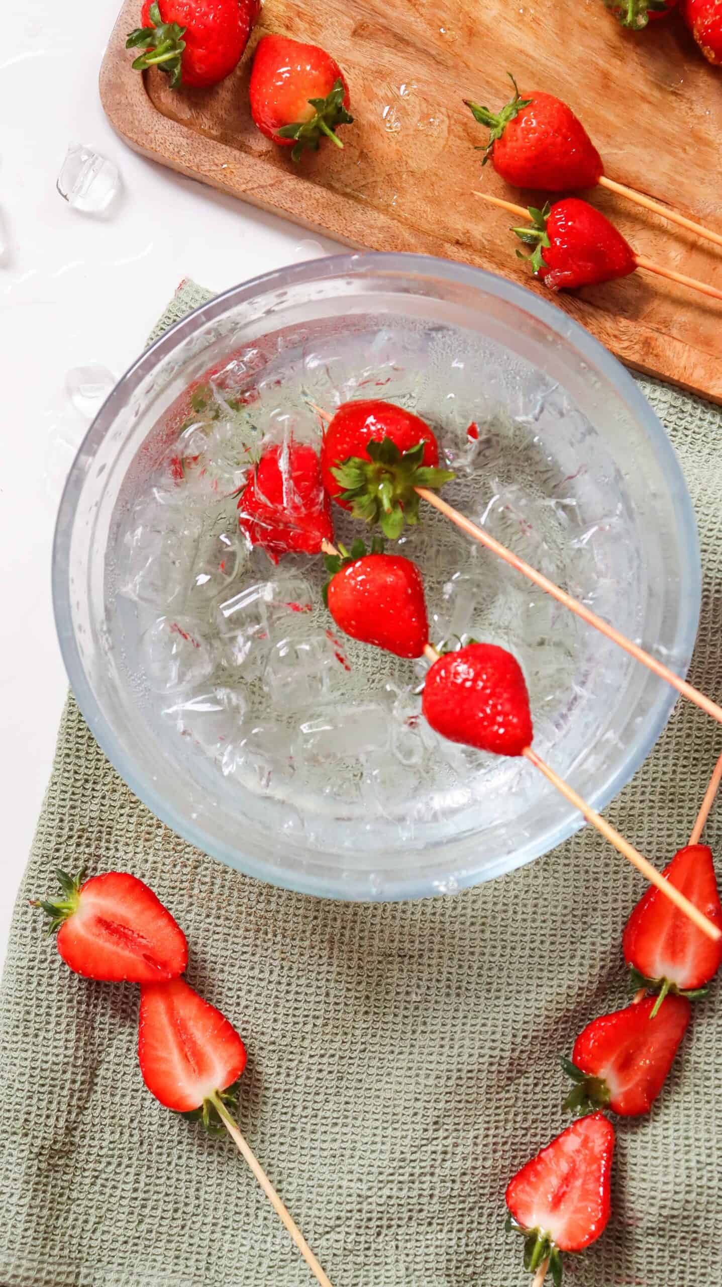 coated strawberries dipped in ice water bath