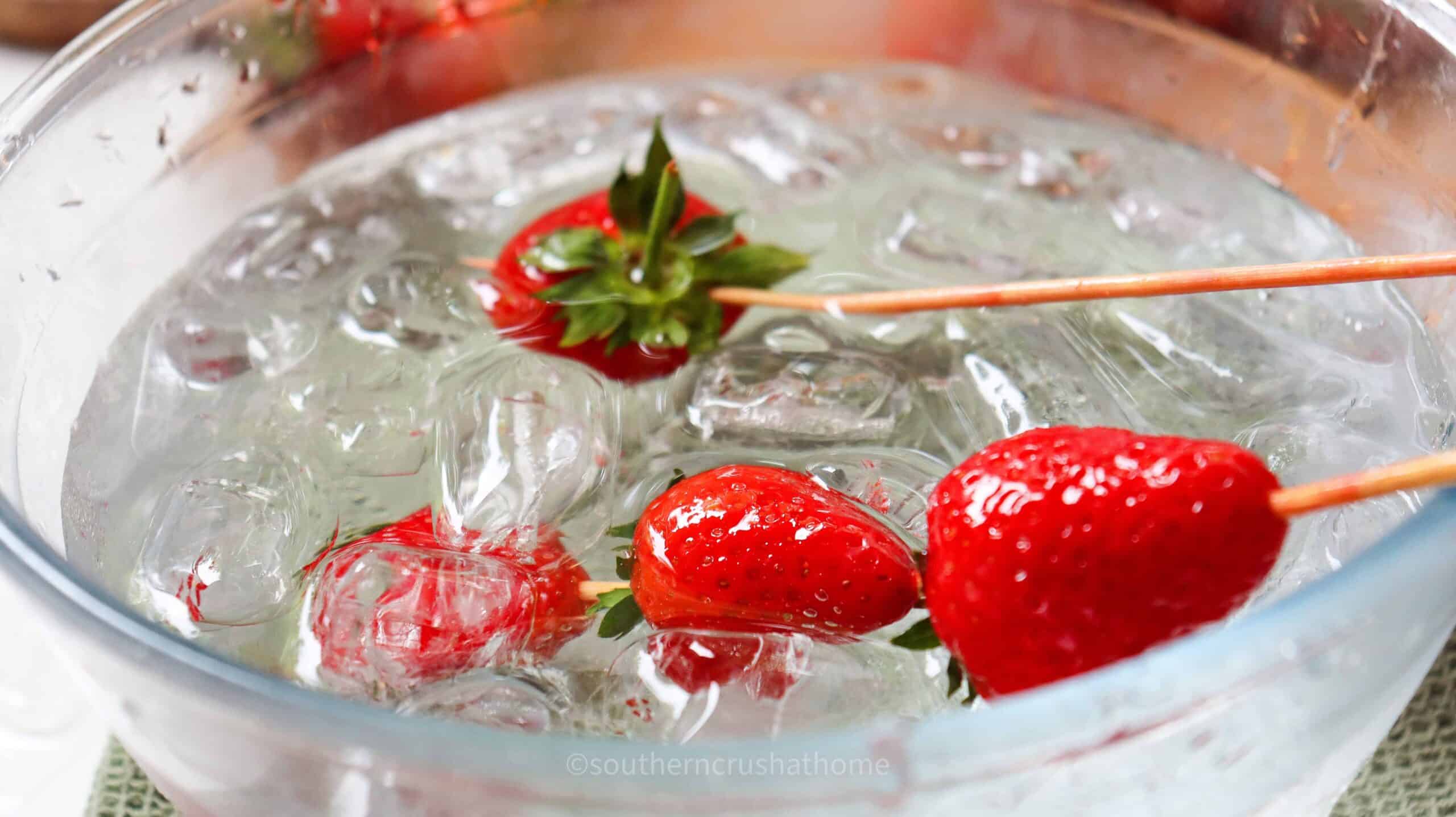 up close of coated strawberries dipped in ice water bath